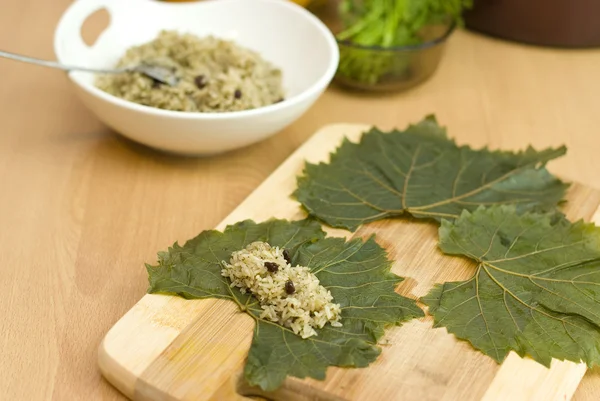 Cooking Turkish food stuffed grape leaves with rice and spices — Stock Photo, Image