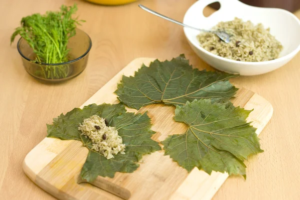 Cooking Turkish food stuffed grape leaves with rice and spices — Stock Photo, Image