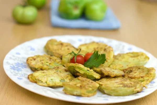 Sliced green tomatoes fried in soft dough with spices — Stock Photo, Image