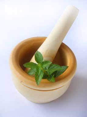 Mint leaves in mortar clipart