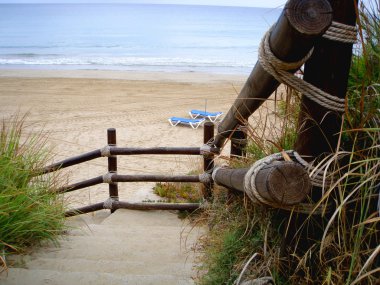 Wooden staircase leading towards sea clipart