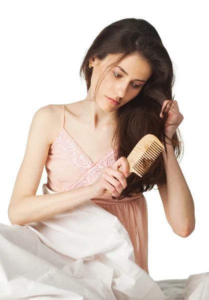 Sad girl combing hair — Stock Photo, Image
