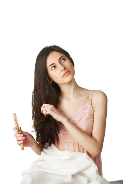 Girl combing hair and looking up — Stock Photo, Image