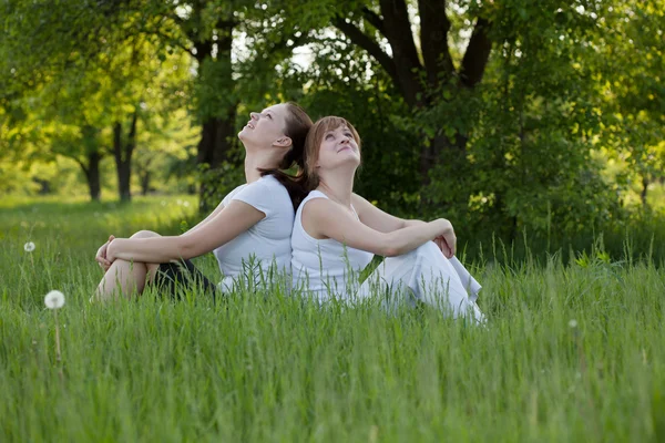 Sisters relax in a park after fitness — Stock Photo, Image