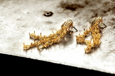 Gold earrings. clipart