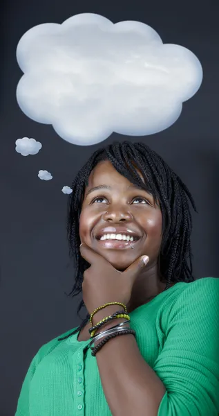 Stock image Dreaming African student with a though bubble