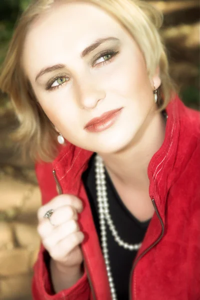 Young blond woman in red jacket — Stock Photo, Image