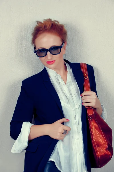 Woman in black jacket with leather bag. — Stock Photo, Image