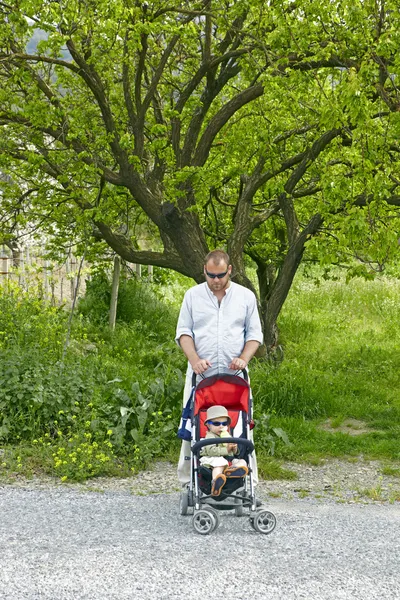 stock image Father and son in sunglasses at the village road