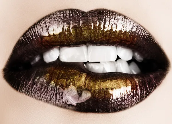 Black gold lips biting. — Stock Photo, Image