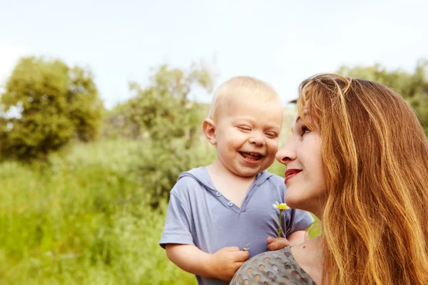 Grandmother and grandson in the green grass — Stock Photo, Image
