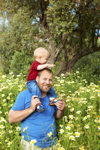 Vader en zoon in bloemen — Stockfoto