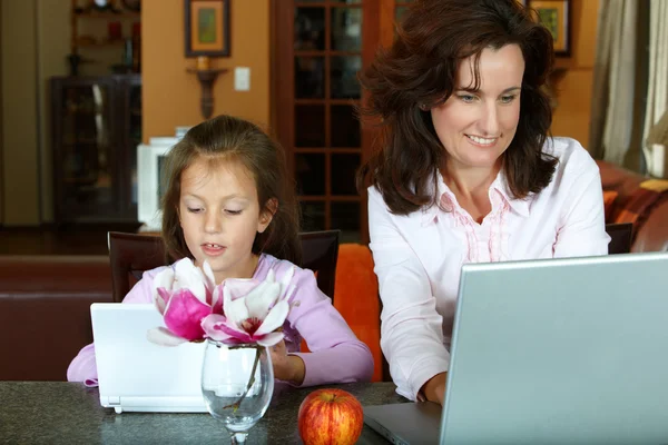 Mother and daughter with laptops — Stock Photo, Image