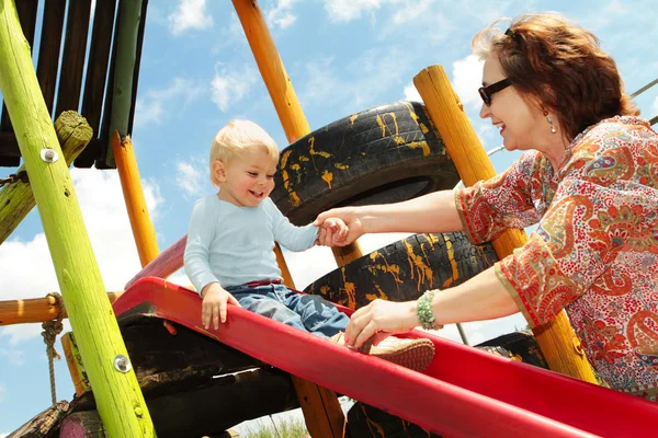 Grandmother and grandson on the playground — Stock Photo, Image