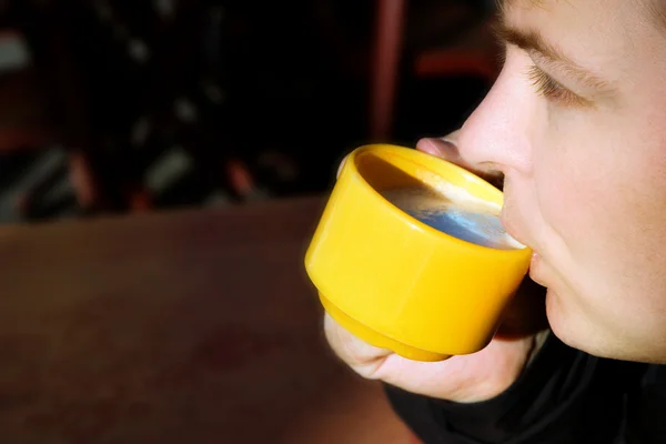 stock image Young man drinking coffee outside