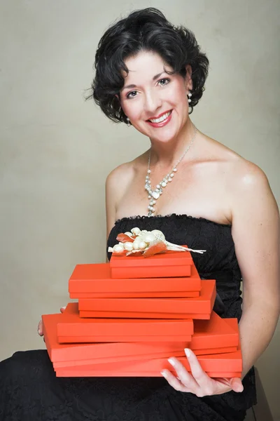 Woman with red boxes — Stock Photo, Image