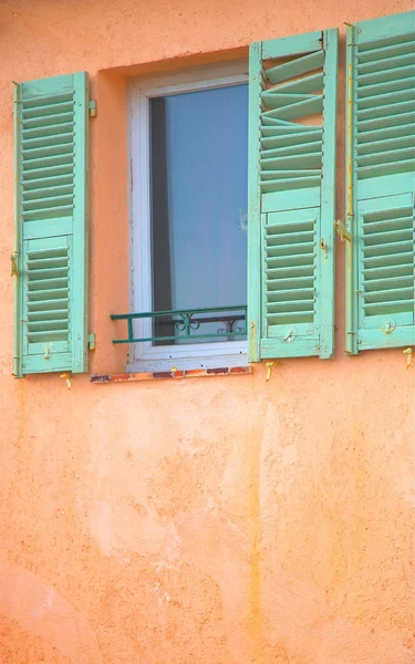 Window with green damaged shutters in France — Stock Photo, Image