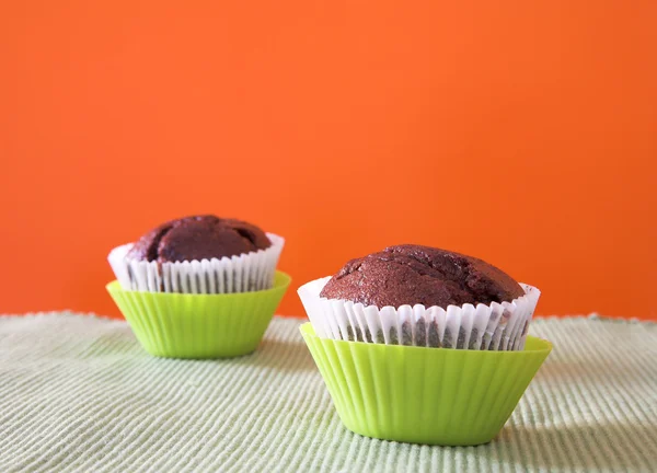 Two muffins in green cups — Stock Photo, Image