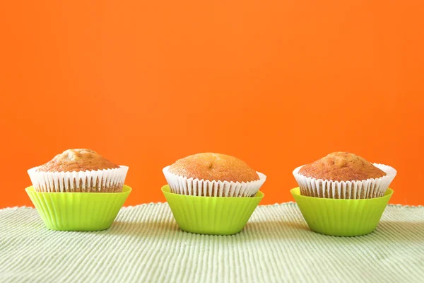 Three muffins in green cups — Stock Photo, Image