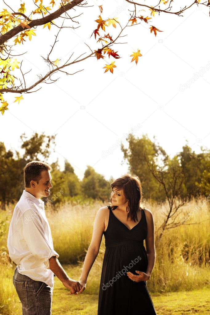 Pregnant woman and husband outdoors