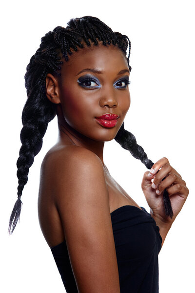 Portrait of beautiful South African young woman with long hair in braids and bright artistic makeup over white background.