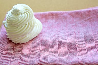 Tasty white meringue on a napkin. clipart