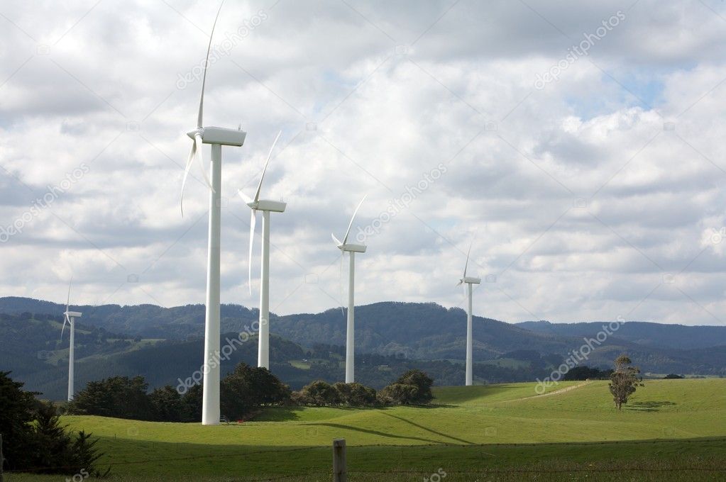 Beautiful green meadow with Wind turbines generating electricity