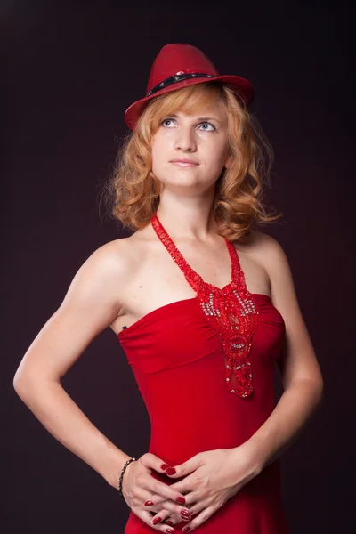 Red-haired girl in a red dress and red hat — Stock Photo, Image