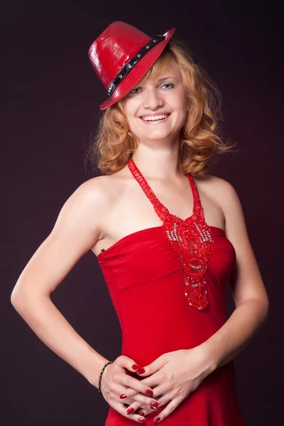 Red-haired girl in a red dress and red hat — Stock Photo, Image