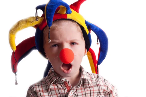 A little boy with a clown nose clown in a hat — Stock Photo, Image