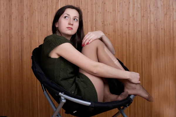 Sad pensive girl in torn tights — Stock Photo, Image