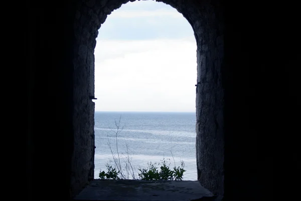 stock image Sea view through the window of an old stone fortress