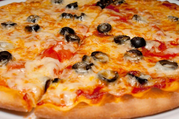 Pizza con aceitunas negras y queso derretido, primer plano —  Fotos de Stock