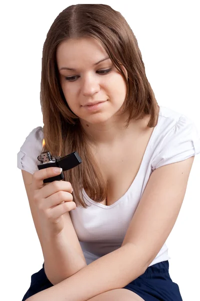 Girl with a cigarette lighter in the hands — Stock Photo, Image