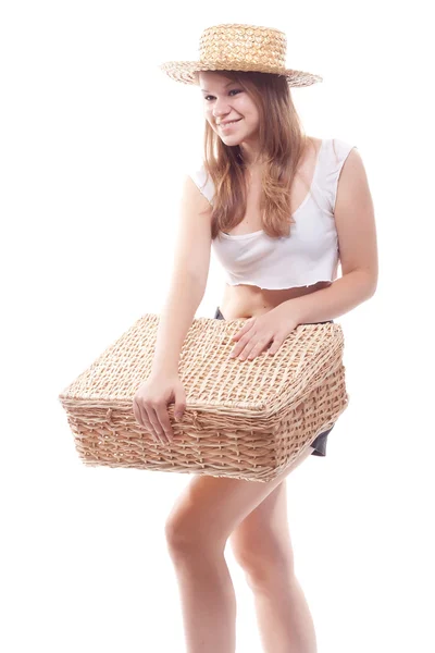 A girl in a straw hat with a straw suitcase — Stock Photo, Image