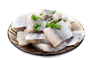 Pieces of herring on a plate clipart