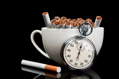 Cup full of cigarettes and stopwatch clipart