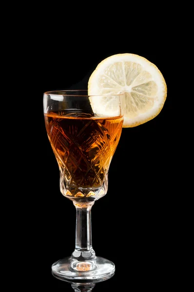 Glass of cognac with lemon — Stock Photo, Image