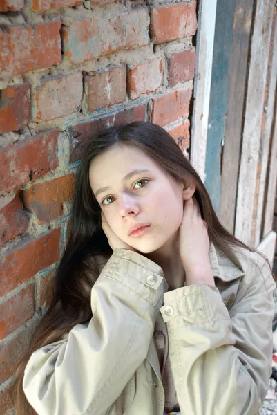 Fată tristă lângă peretele de cărămidă — Fotografie, imagine de stoc
