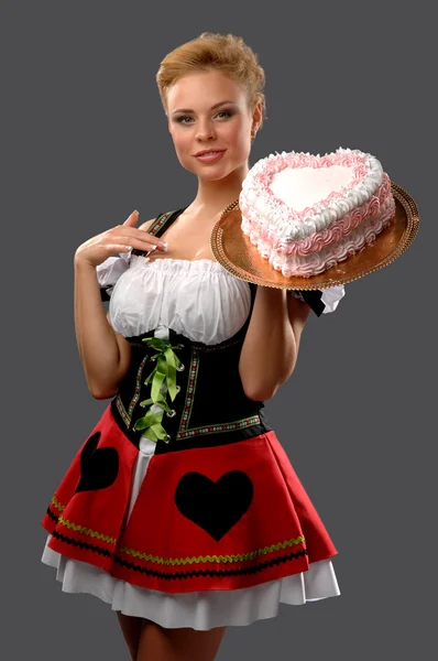 Pretty housewife with a big cake — Stock Photo, Image