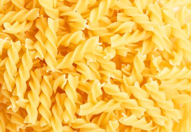 Fusilli swirl pasta forming a background clipart