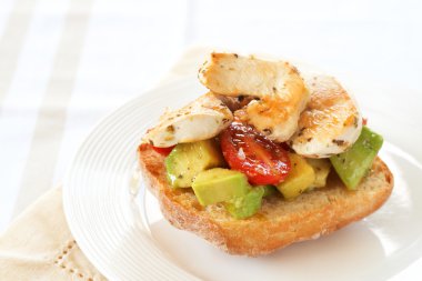 Tasty avocado, tomato and chicken bruschetta clipart