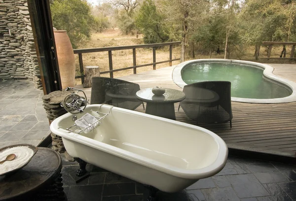 stock image Bath with a view over a deck and a pool in Africa