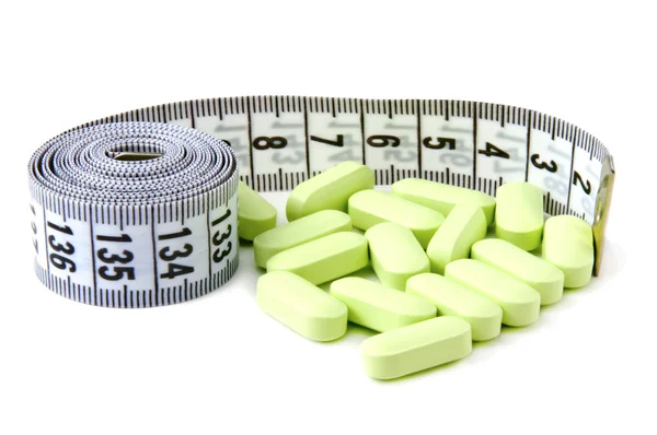 Measure tape and pills — Stock Photo, Image