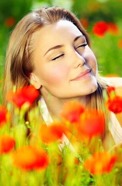 Beautiful female laying on the flower filed — Stock Photo, Image