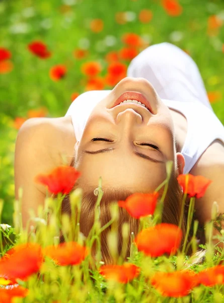 Beautiful female laying on the flower filed — Stock Photo, Image