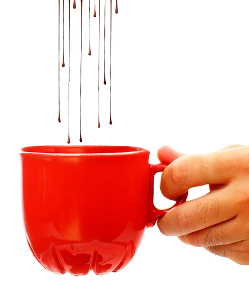 Hot chocolate dropping into coffee cup — Stock Photo, Image