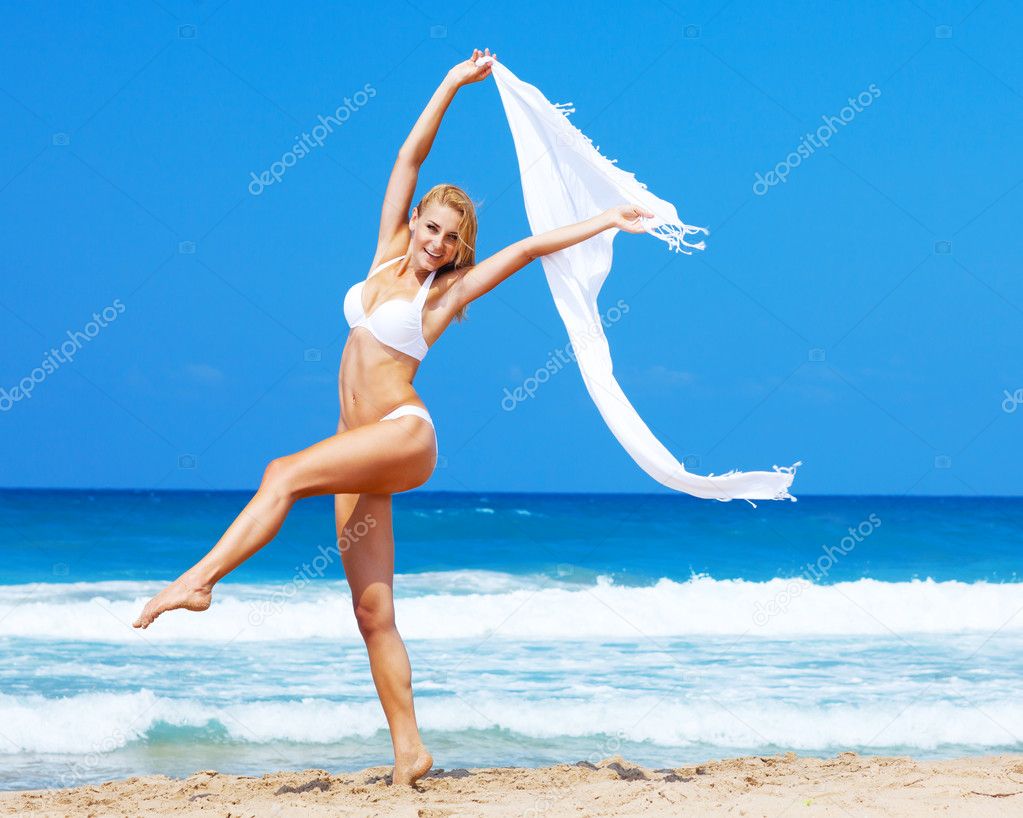 Dancing happy girl on the beach