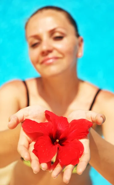 Beautiful female holding red flower — Stock Photo, Image