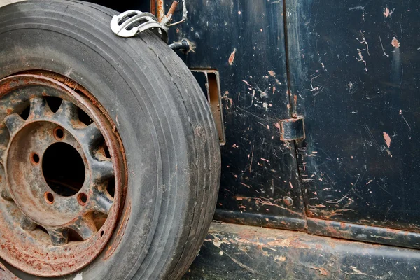 Rusty wheel on the side of an old car — Stock Photo, Image